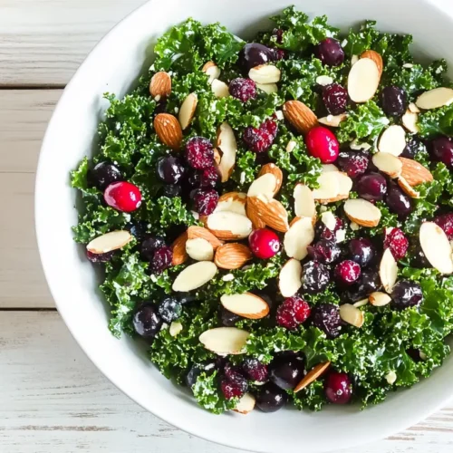 Close-up of kale salad with cranberries and almonds.