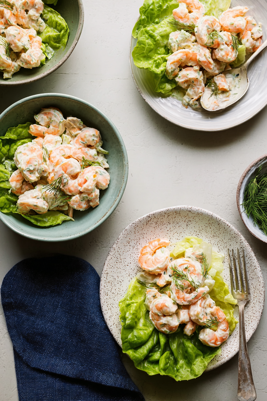 Creamy shrimp ceviche served on crisp lettuce with fresh dill and light dressing, a refreshing seafood salad dish