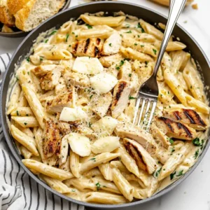 Garlic parmesan chicken pasta dinner with garlic bread and wine