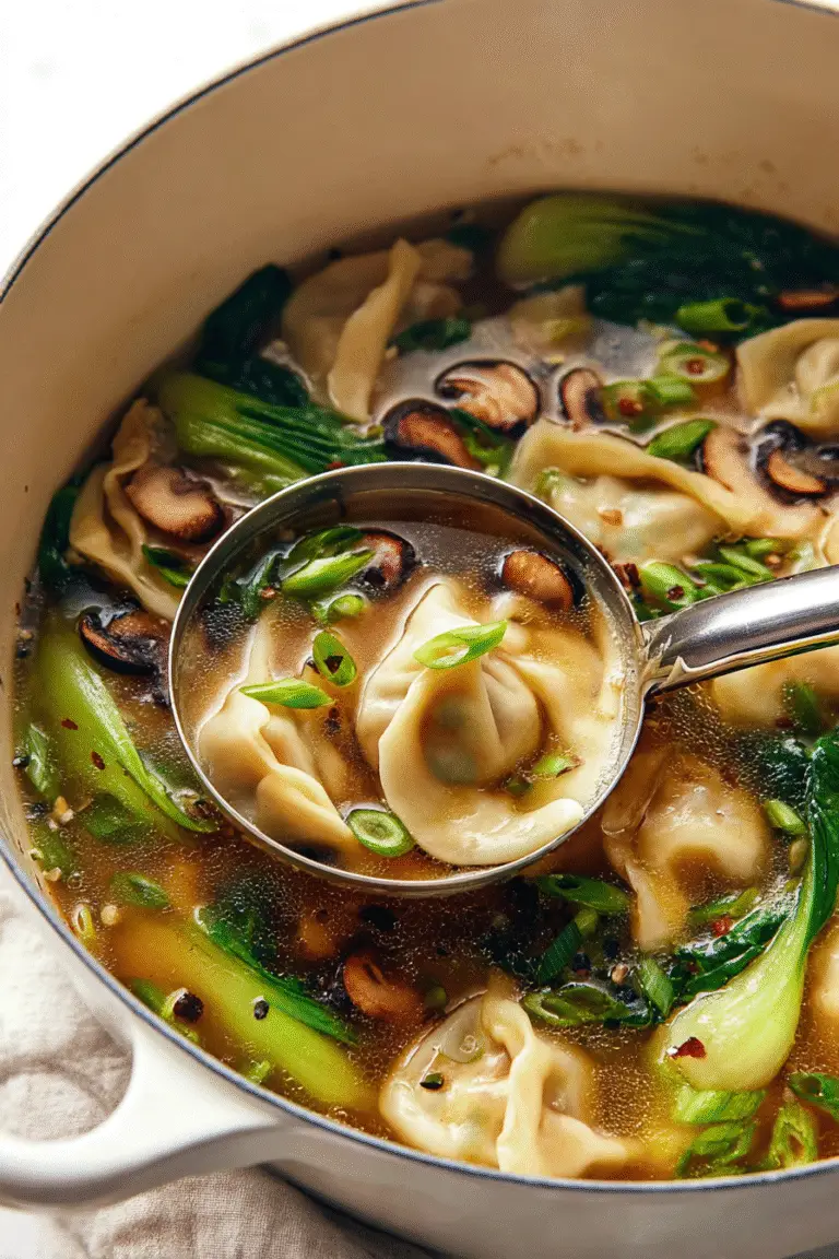 Ladle lifting dumpling from potsticker soup filled with bok choy, mushrooms, and green onions in golden broth.